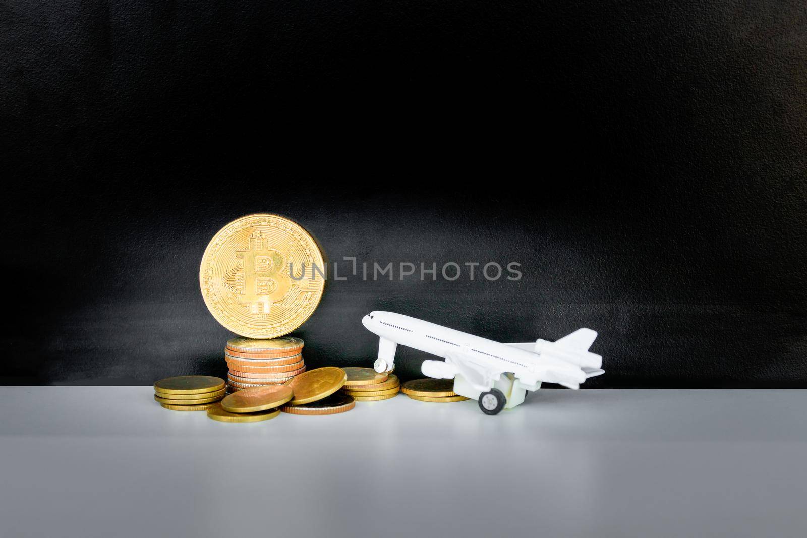 bitcoin coins and money stack and model of passenger plane  over white on black background. with copy space add text. color retro style by pramot