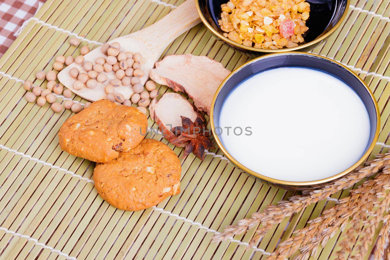 cereal cookies milk in bowl Cornflakes spices on wooden bamboo and copy space for text. top view by pramot