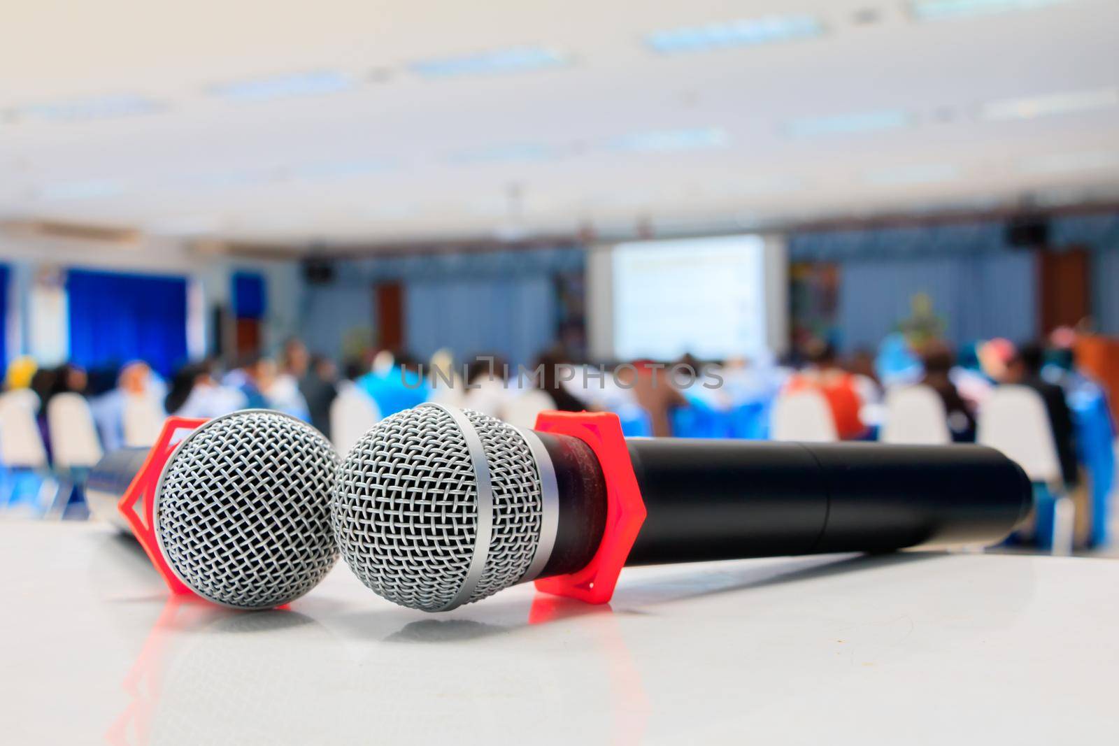 Close up microphone wireless old on the table in the conference and Background blur interior seminar meeting room