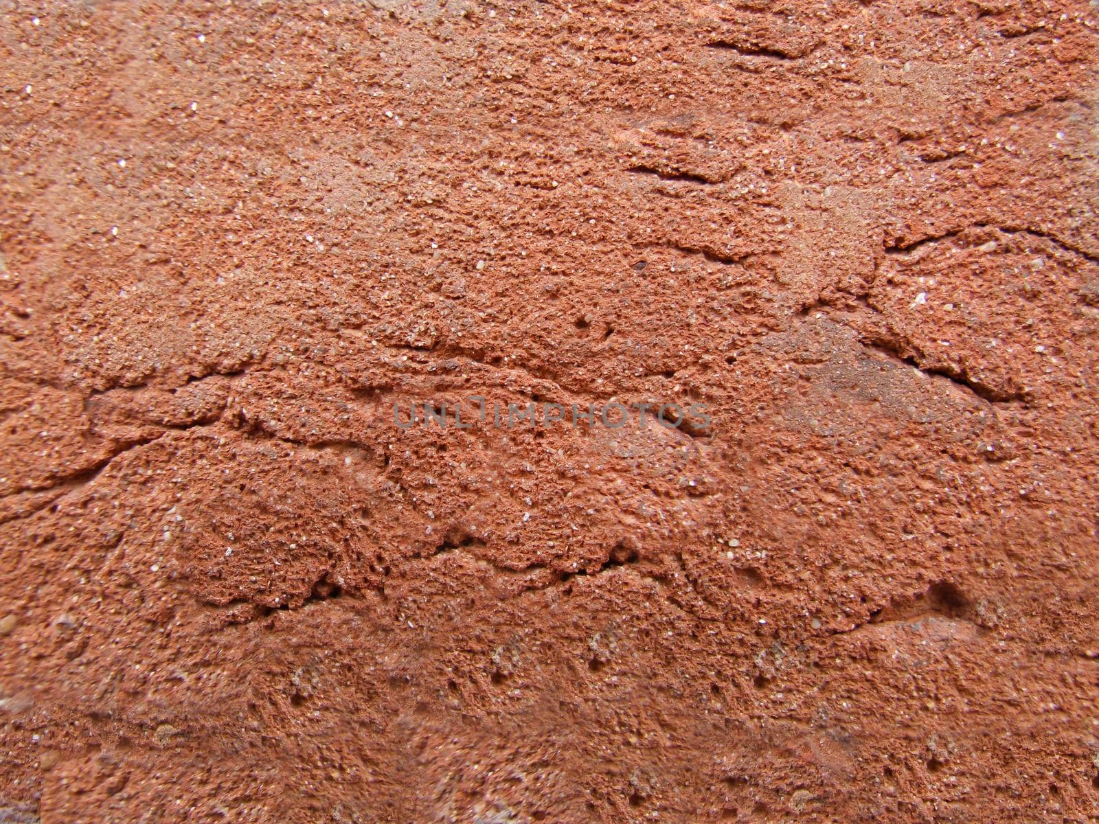 Decorative coating with cracks and roughness of red color.Texture or background
