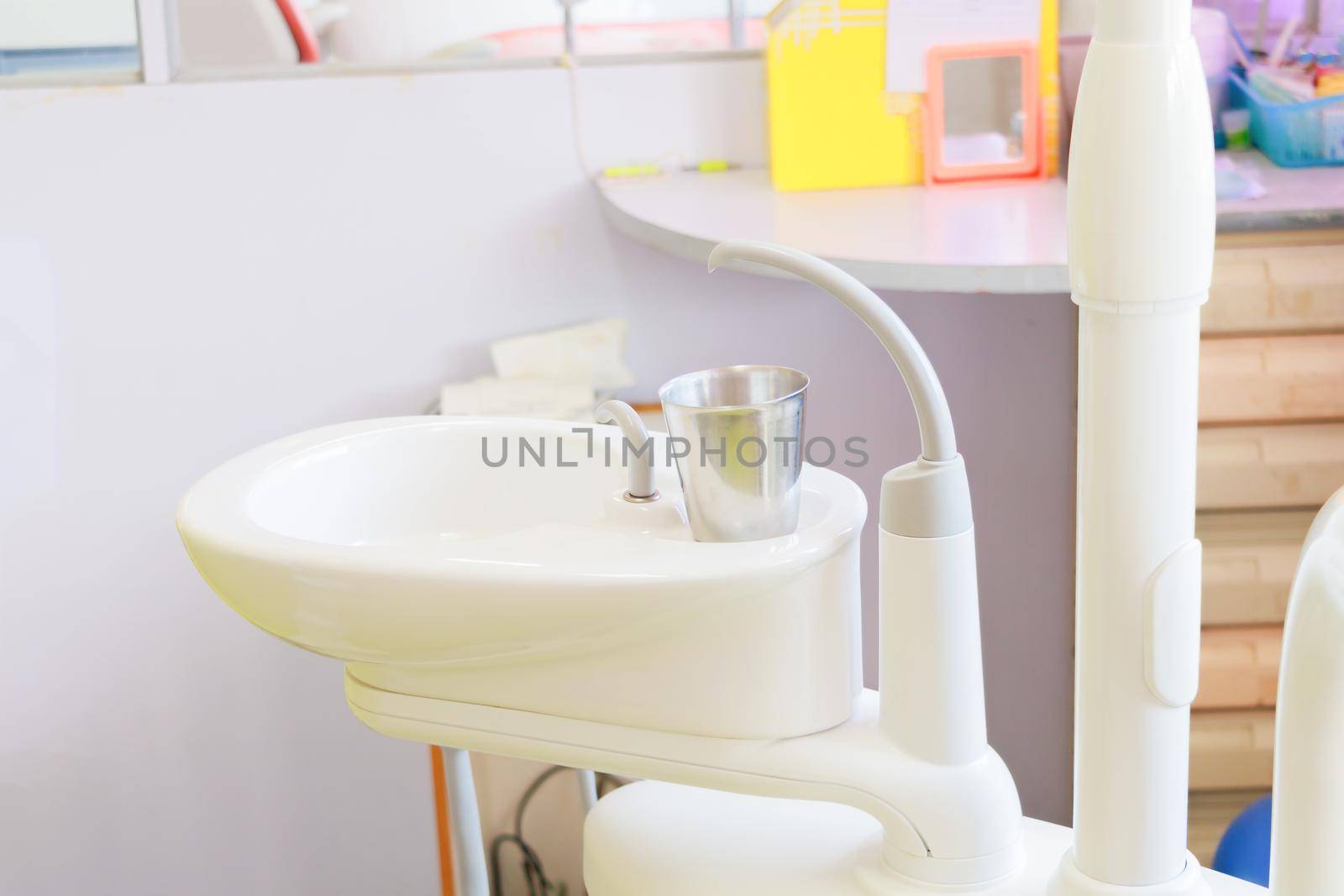 glass chromium on Sink medical equipment dentist Close up, ceramic spittoon and water filler in Clinic