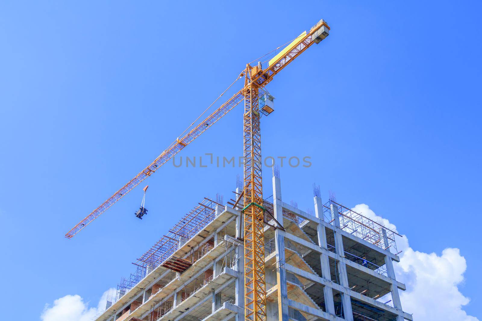 high big construction site in develop city and tower crane working. with copy space add text by pramot