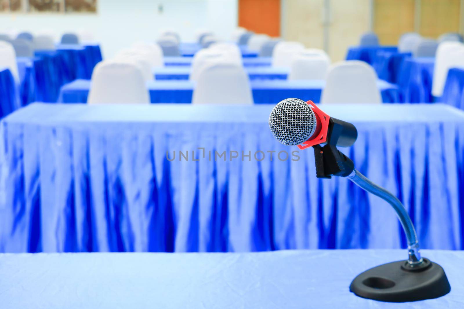 microphone wireless on a stand in interior meeting room seminar empty conference background: Select focus with shallow depth of field. by pramot