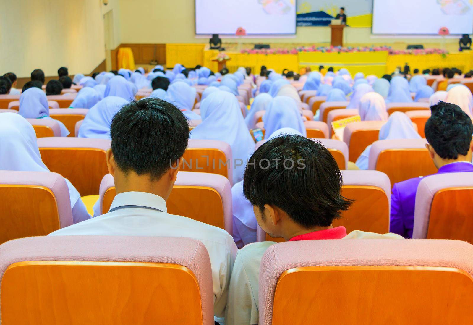 Students education sit on chair orange interior classroom learning in university