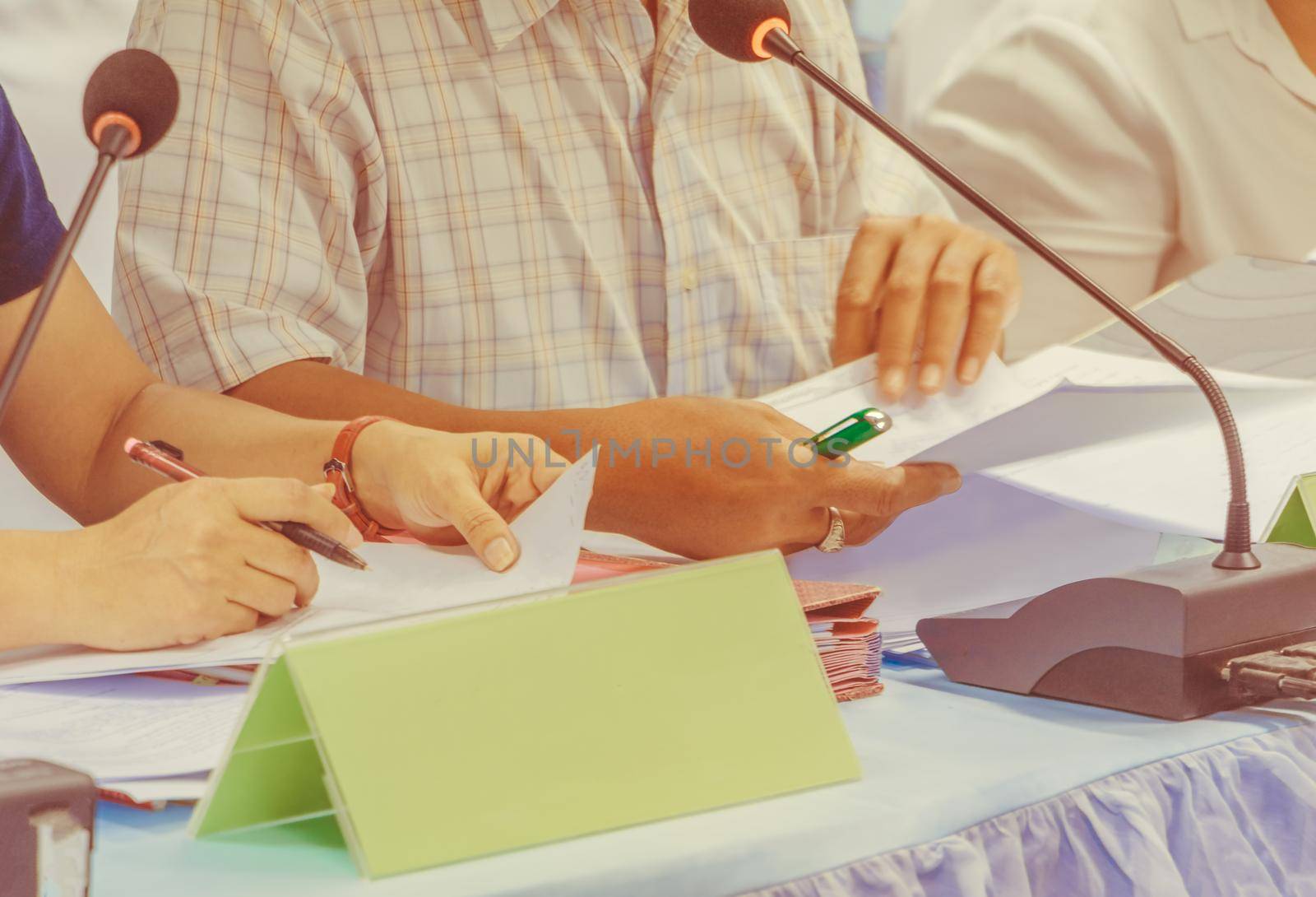 hands business and papers on table present a meeting seminar with copy space add text. warm retro tone color