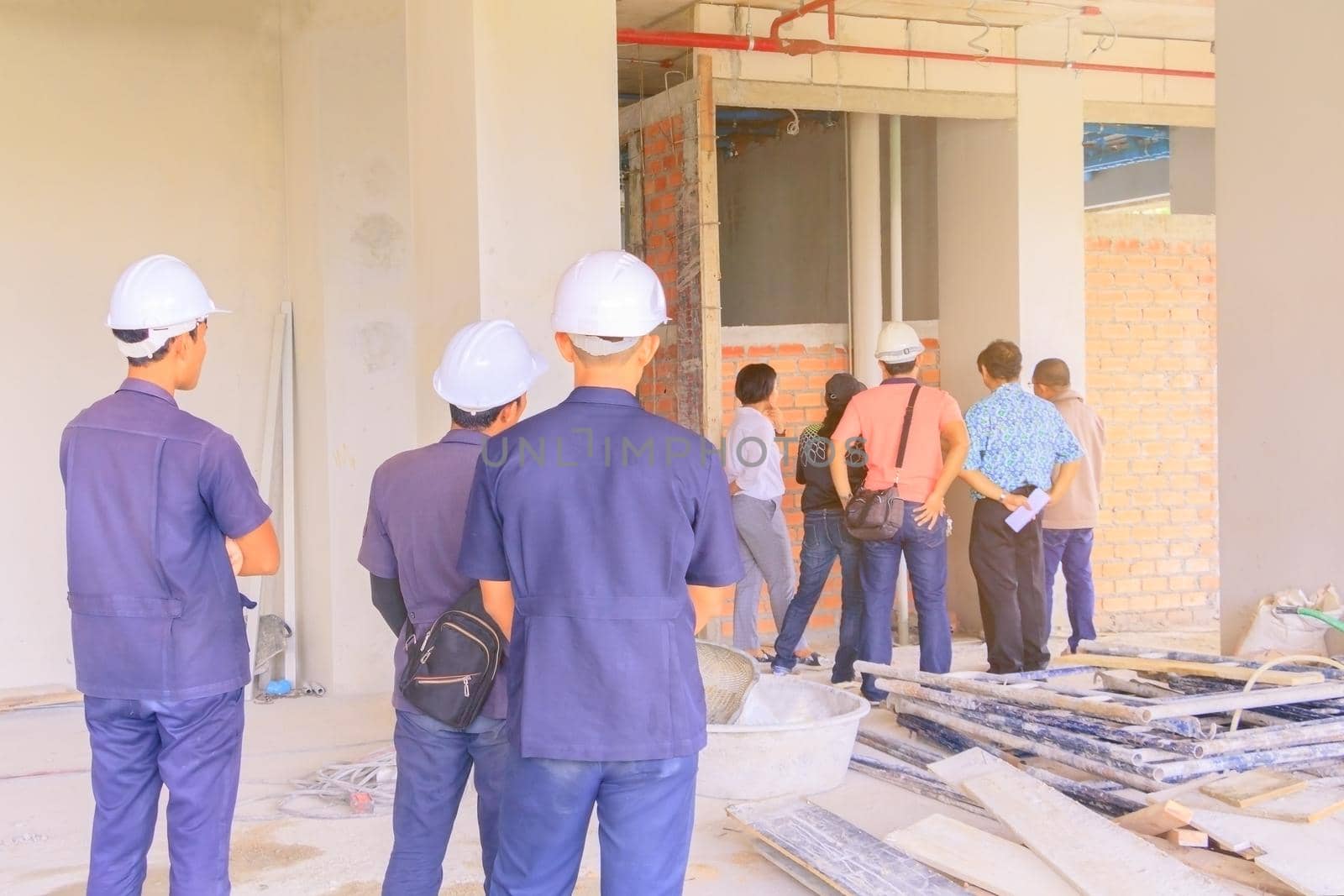 construction site and engineer check build plan development on housing High rise building by pramot