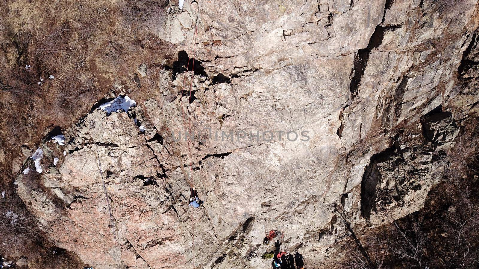 A group of people are engaged in rock climbing. by Passcal