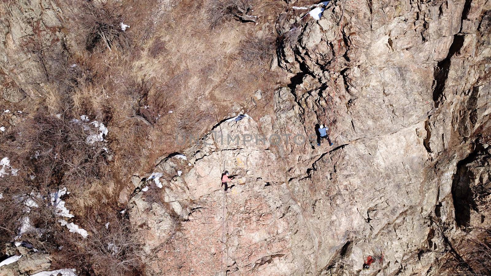 A group of people are engaged in rock climbing. by Passcal