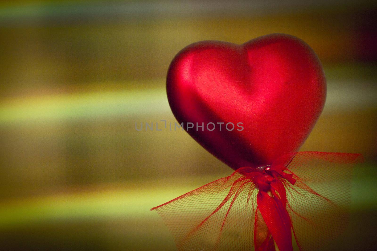 Shiny red heart on rainbow background. Copy space