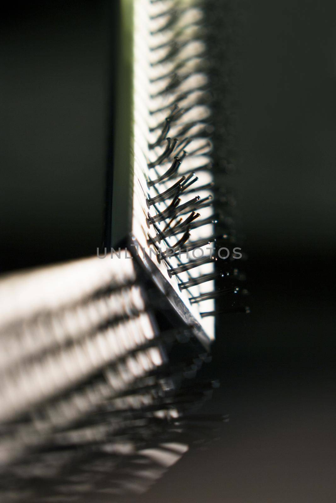 Hair brush with plastic bristles for straightening hair. No people