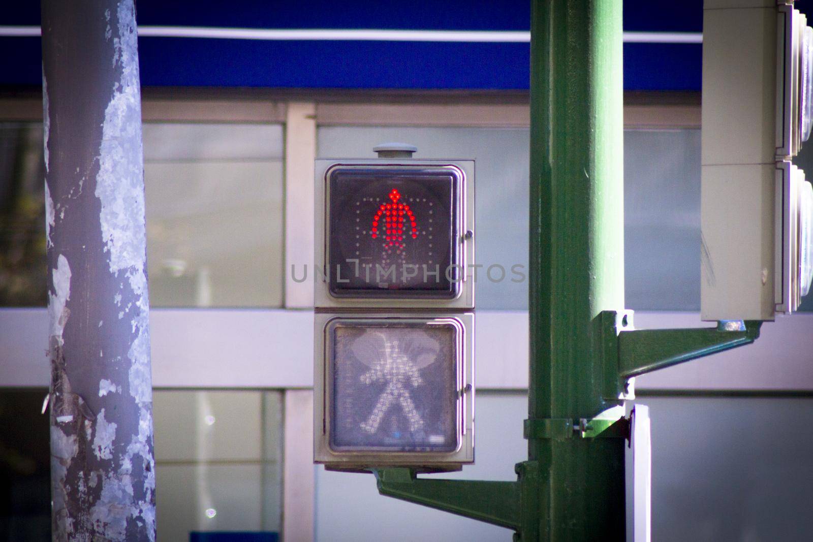 Traffic light on the street with red signaling for pedestrians. No people