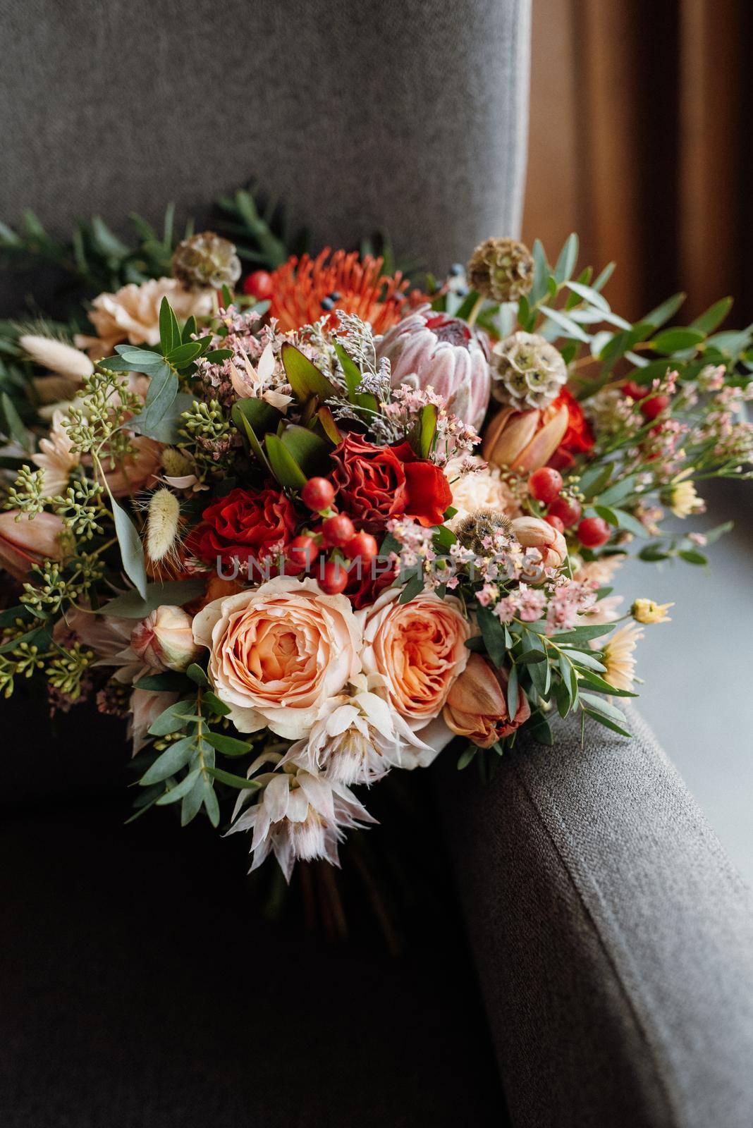 bridal bouquet in red autumn shades of Kenyan dried flowers