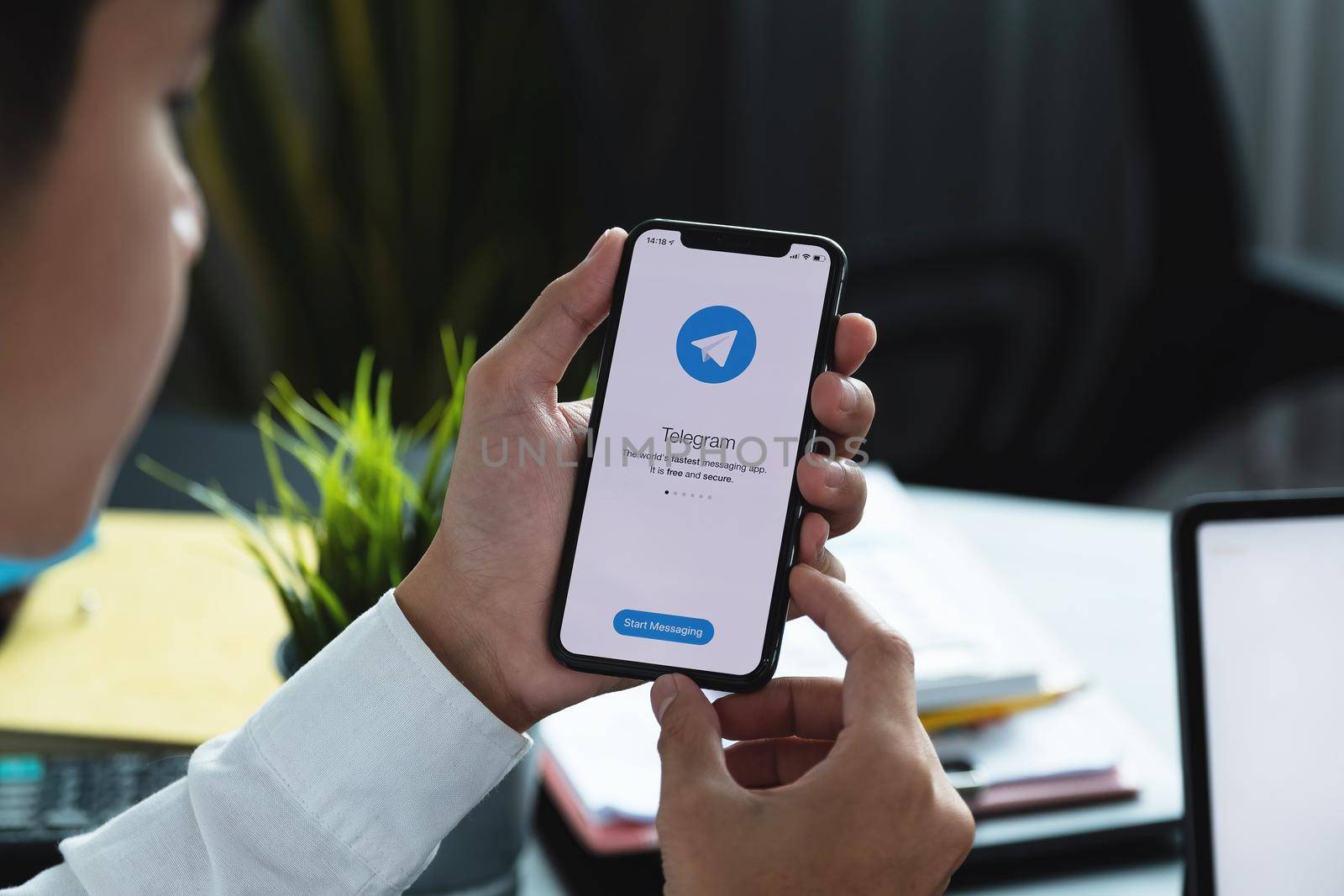 CHIANG MAI, THAILAND, APR 06, 2021 : Woman hand holding iPhone X with social networking service Telegram on the screen. iPhone 10 was created and developed by the Apple inc