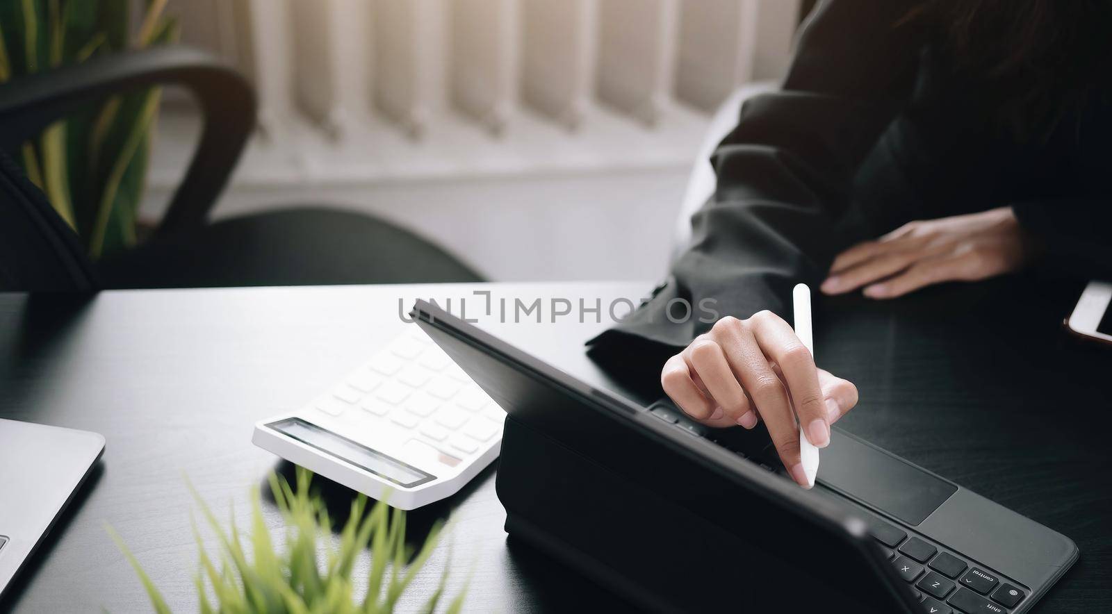 businesswoman use a digital tablet to check financial data. by wichayada