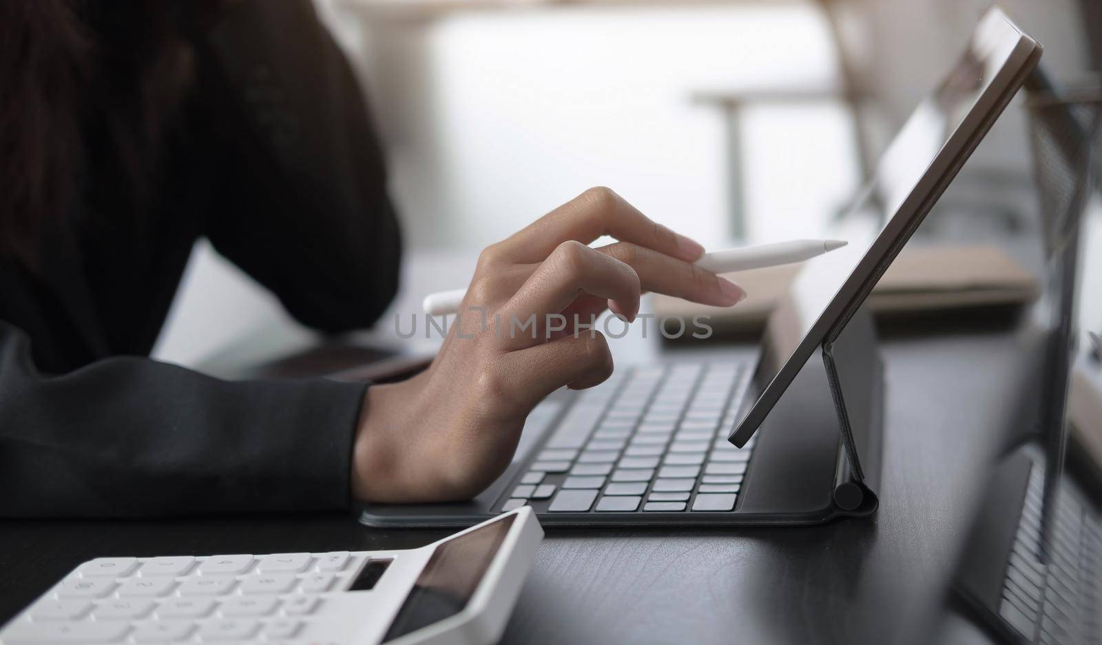 businesswoman use a digital tablet to check financial data. by wichayada