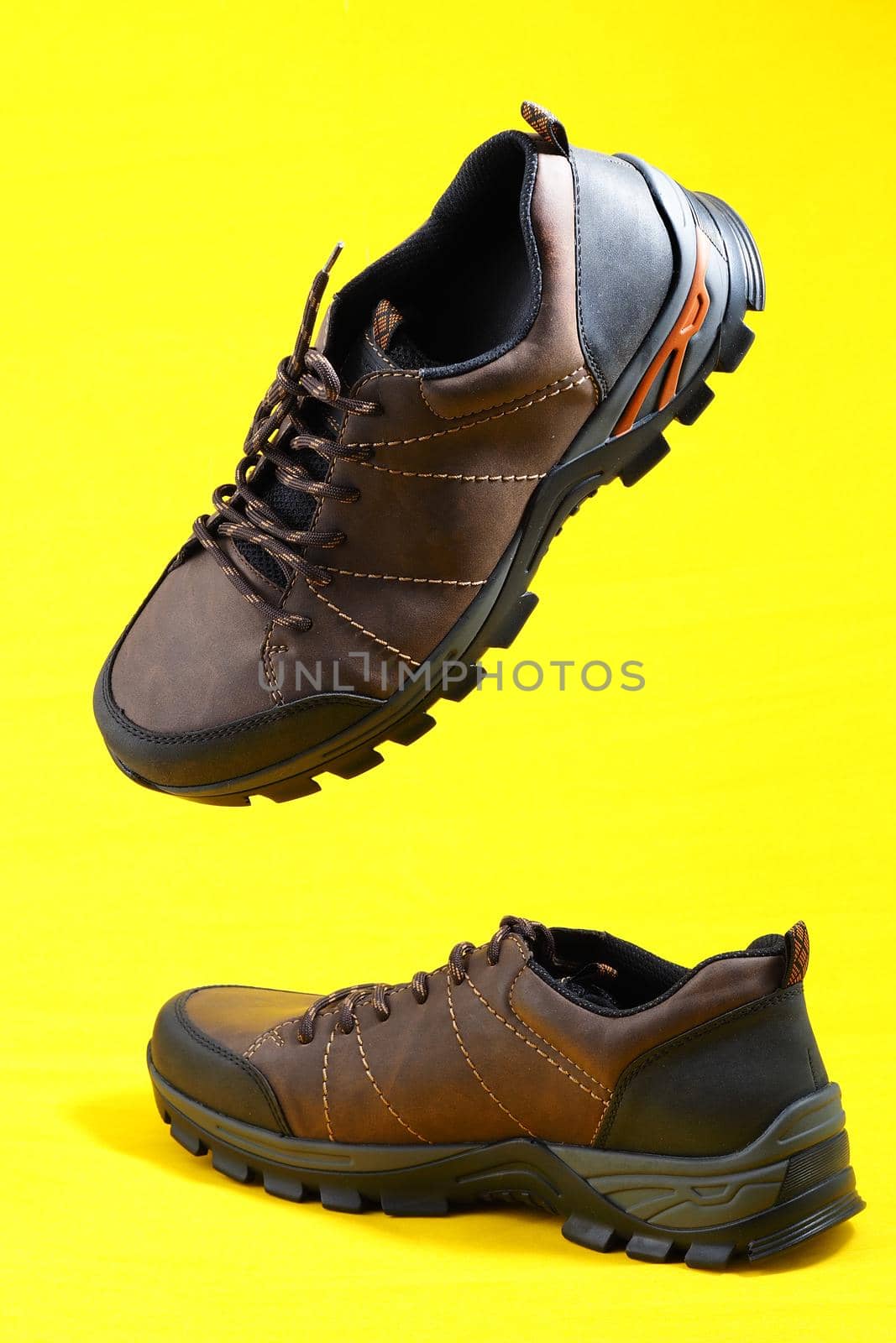 Men's shoes. Stylish sneakers on a yellow background. Isolated, close-up, levitation. High quality photo