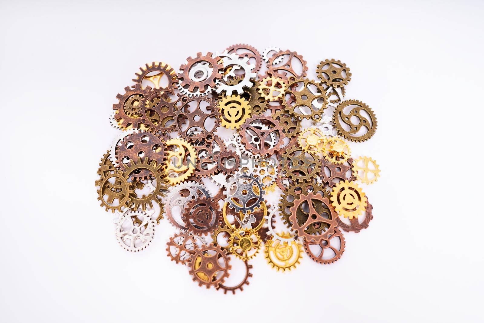 Pile of gear wheels and cogs in different colors by Mendelex