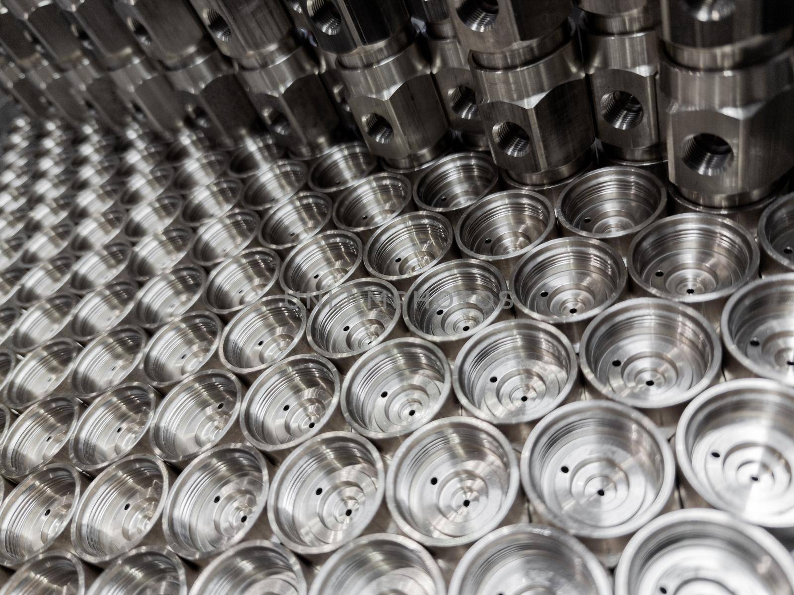 shiny steel industrial production parts after turning - close-up with selective focus