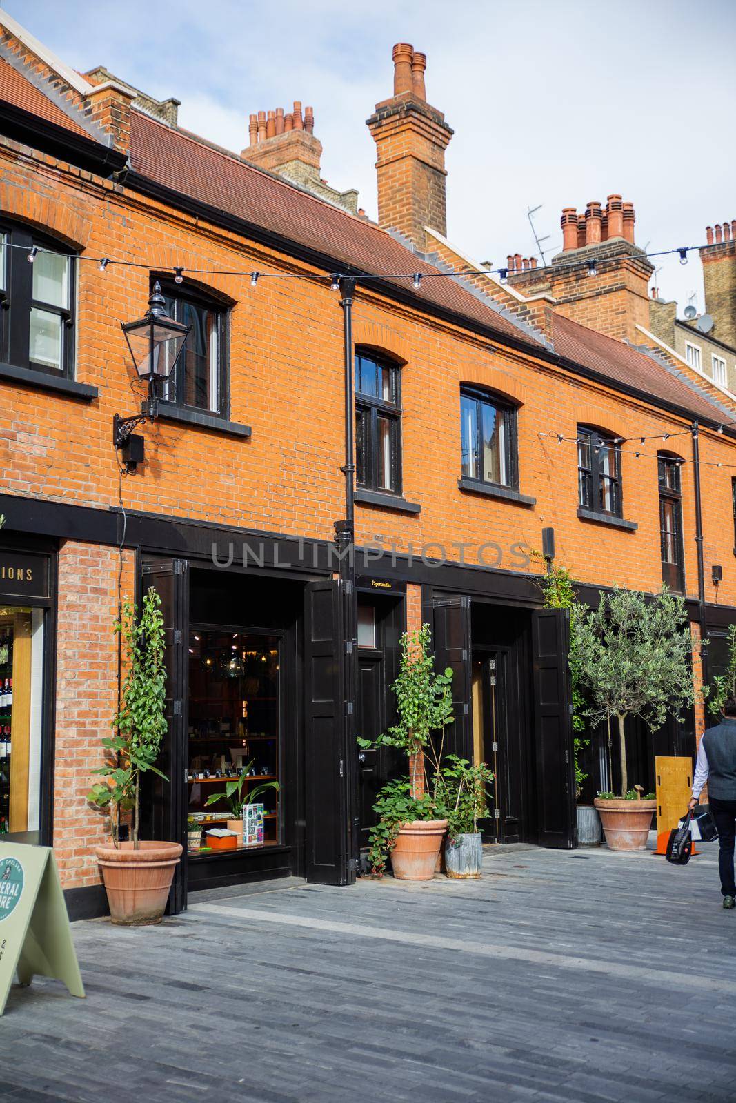 London, UK - February 14, 2020: Row of brick buildings with restaurants in Pavilion Road. Beautiful British brick buildings with classic architecture. Colorful London neighborhood