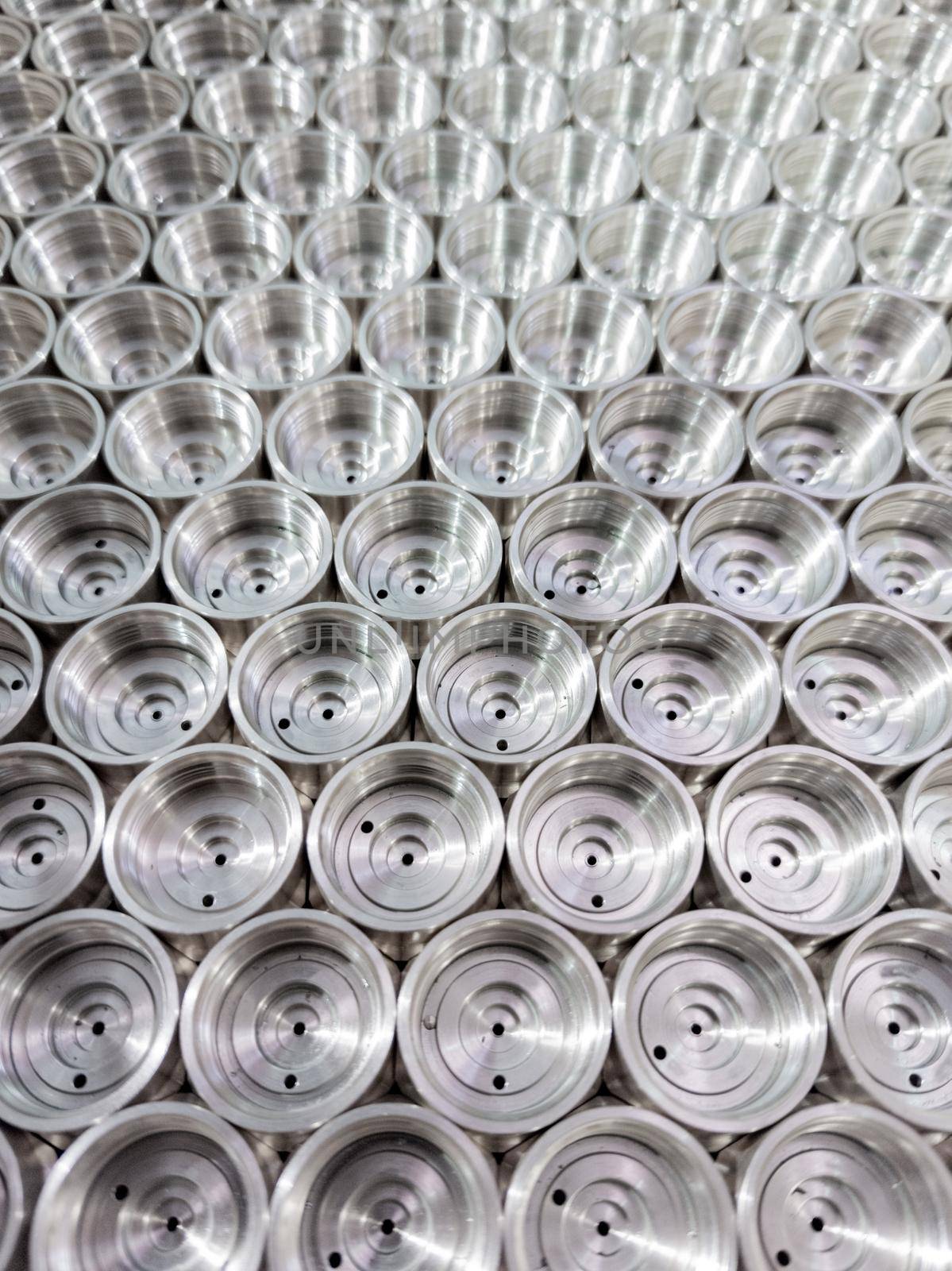 shiny steel industrial production parts after turning - close-up with selective focus