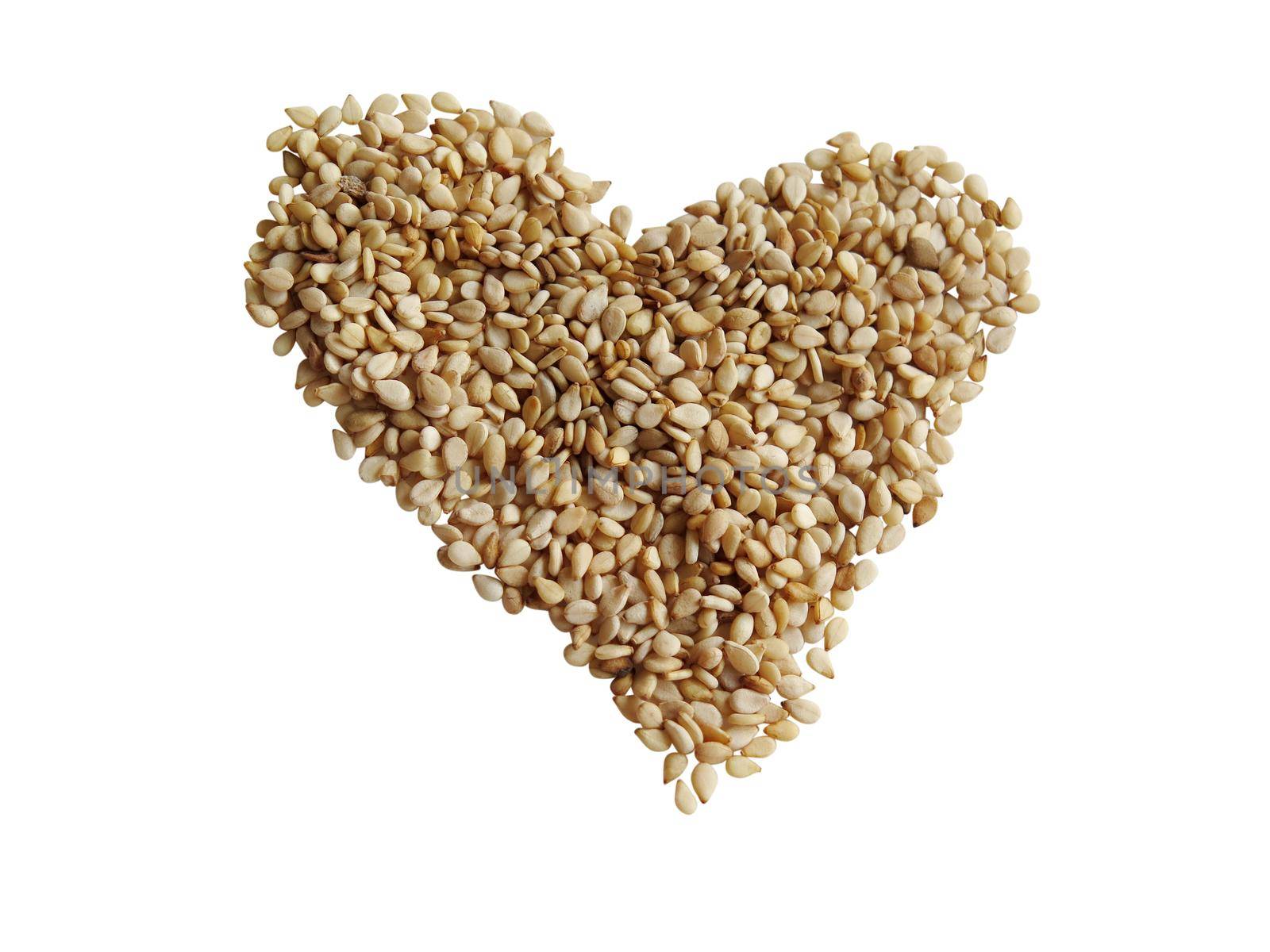 Sesame seeds in the form of heart on a white background