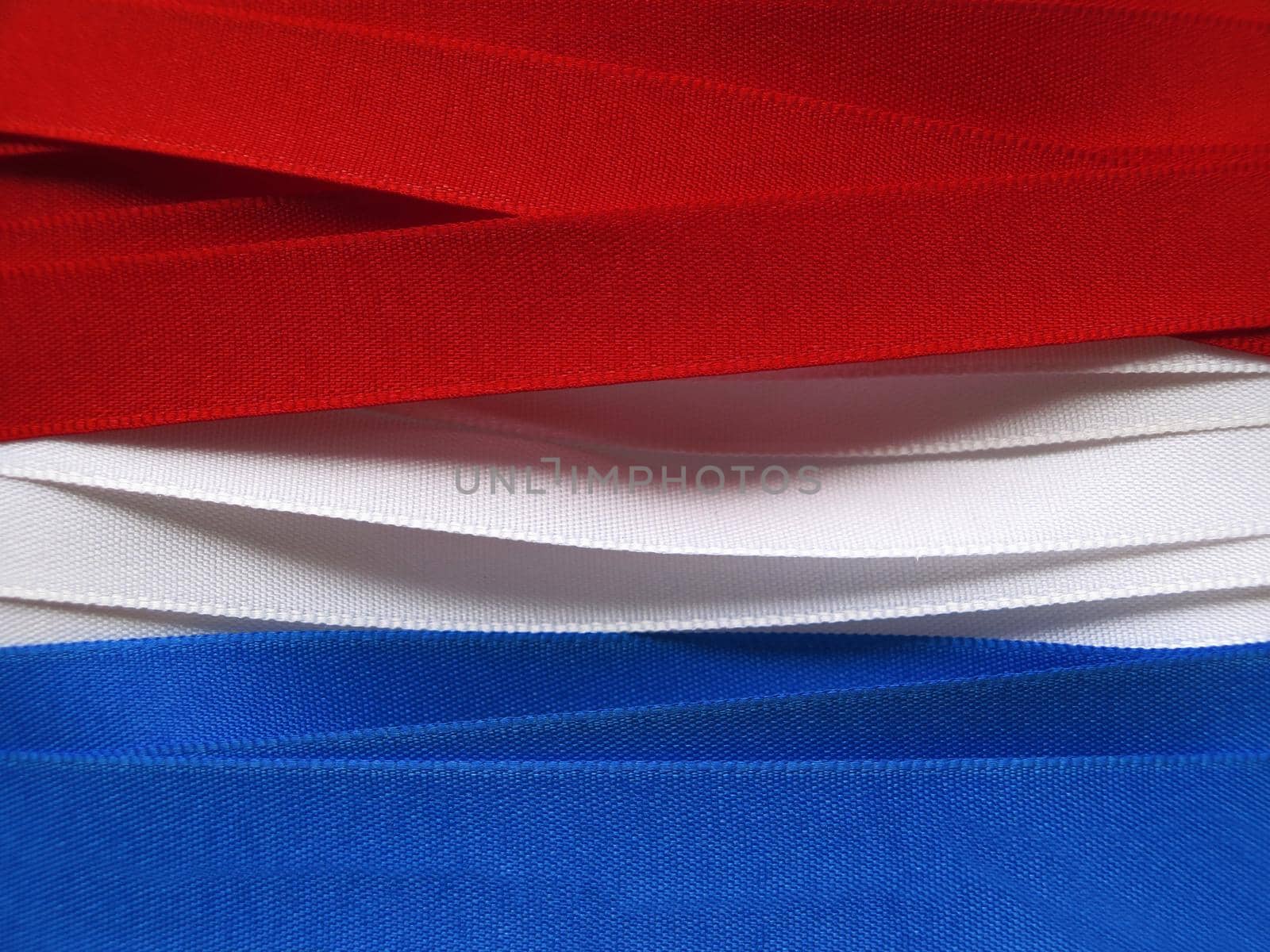 Luxembourg or Paraguay flag or banner made with red, blue and white ribbons