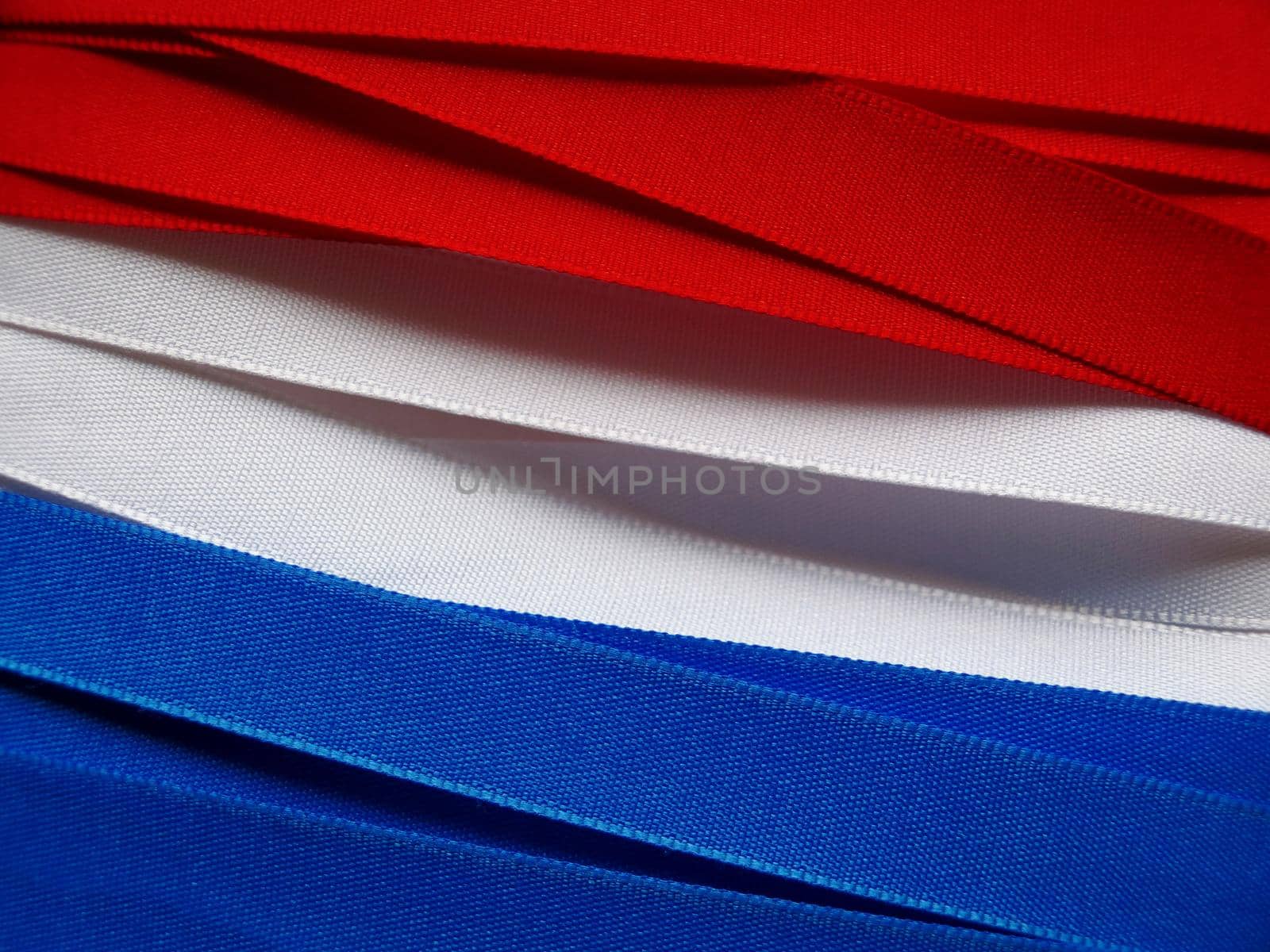 Luxembourg or Paraguay flag or banner made with red, blue and white ribbons