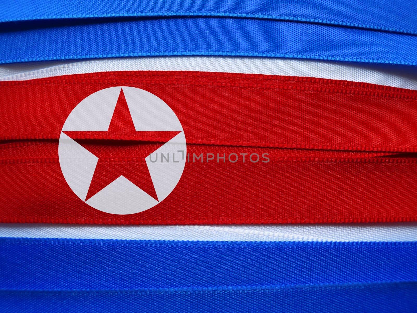 North Korea flag or banner made with red, blue and white ribbons