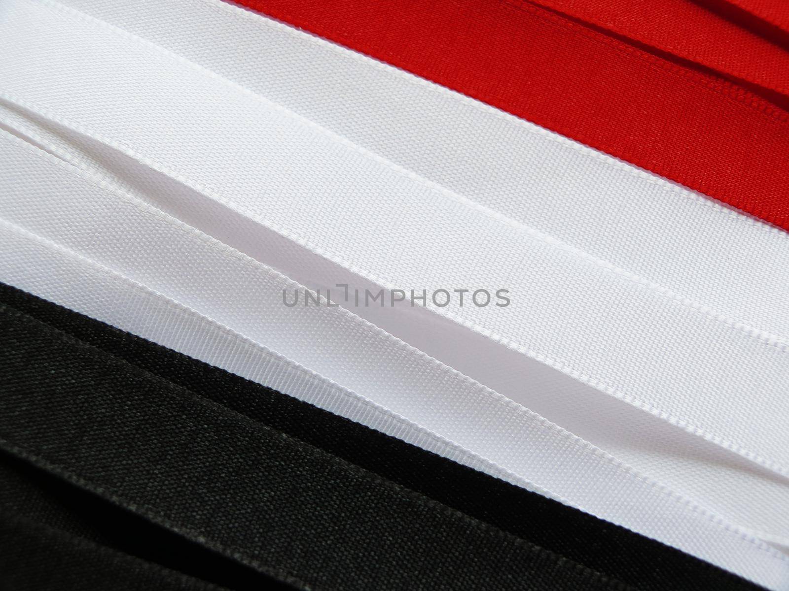 Iraq flag or banner made with red, white and black ribbons