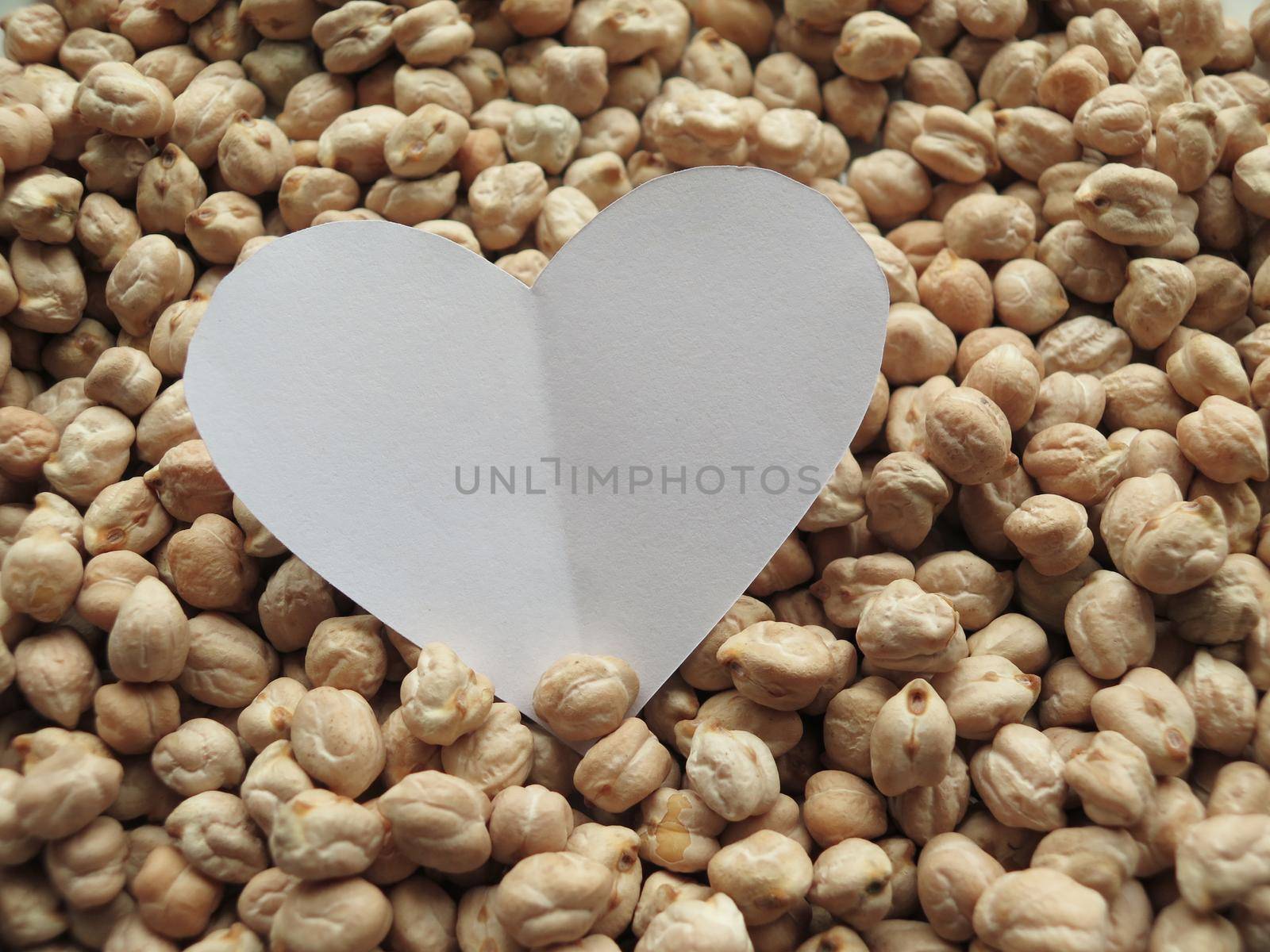 Closeup of White Heart shape on pattern of chickpeas. healthy food by aroas