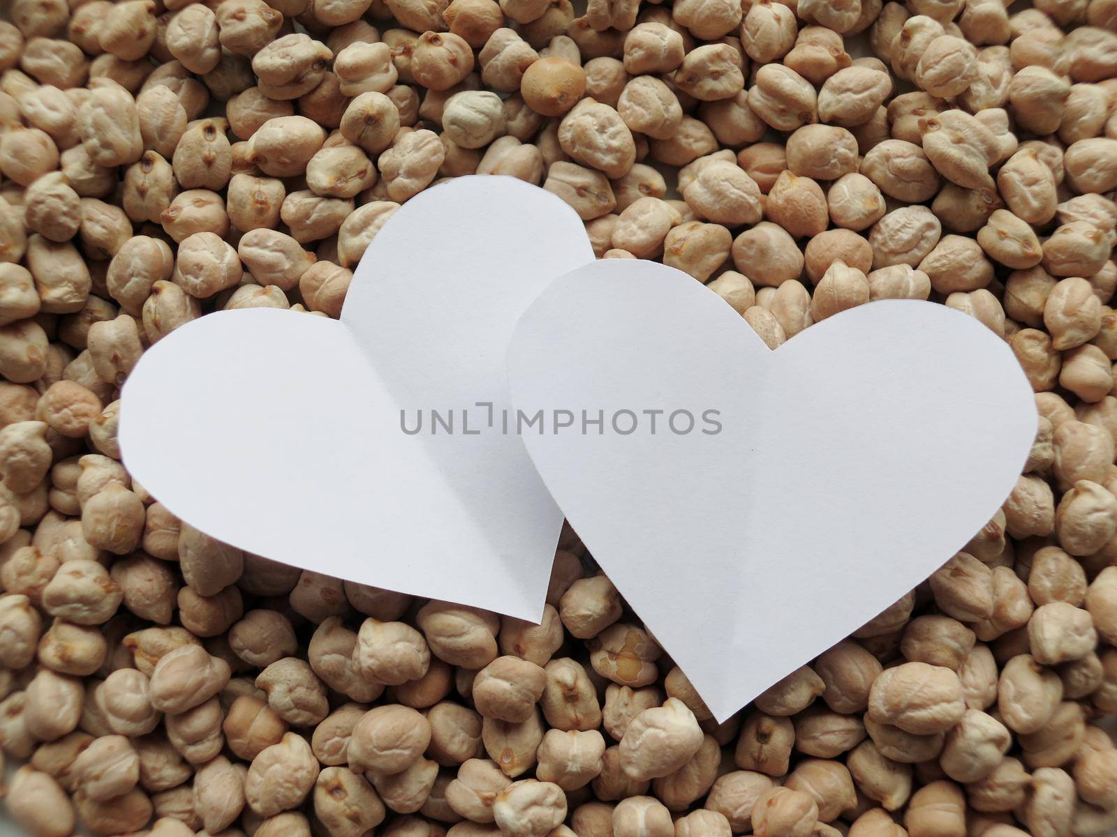 Closeup of White Heart shape on pattern of chickpeas. healthy food by aroas