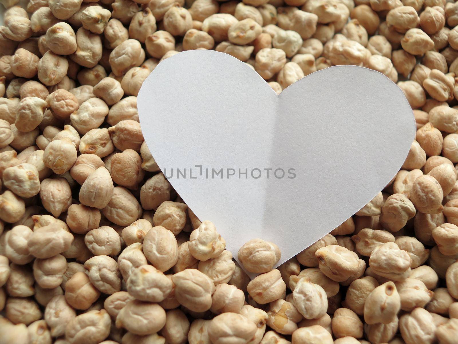 Closeup of White Heart shape on pattern of chickpeas. healthy food by aroas