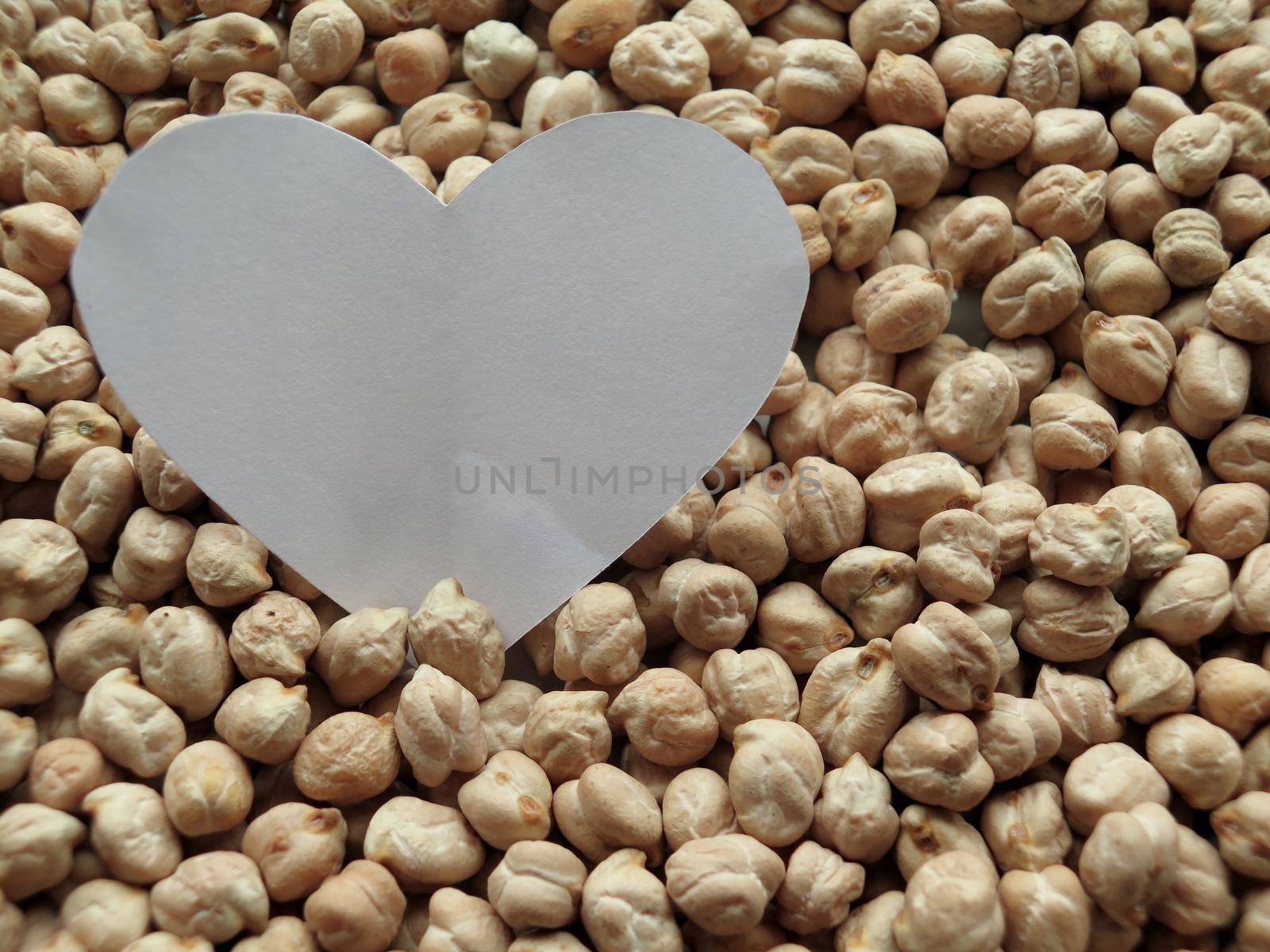 Closeup of White Heart shape on pattern of chickpeas. healthy food by aroas