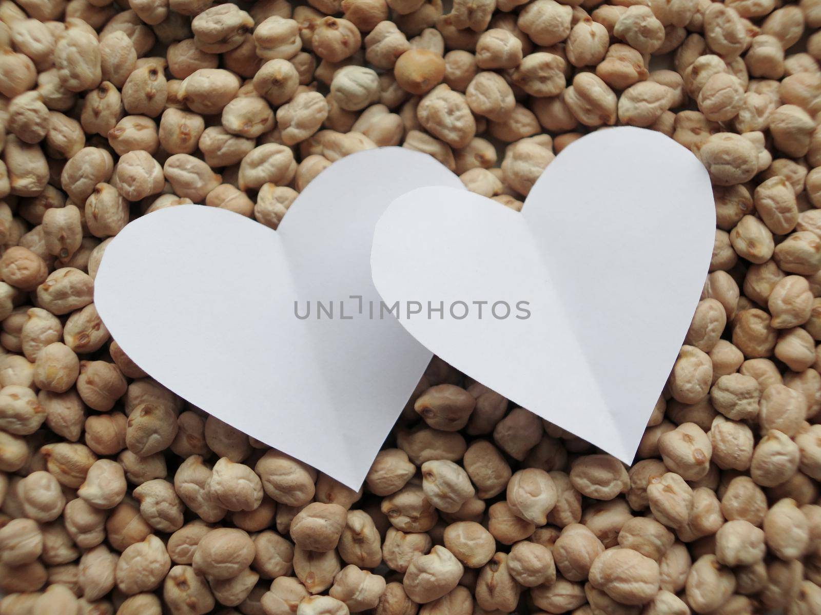 Closeup of White Heart shape on pattern of chickpeas. healthy food by aroas