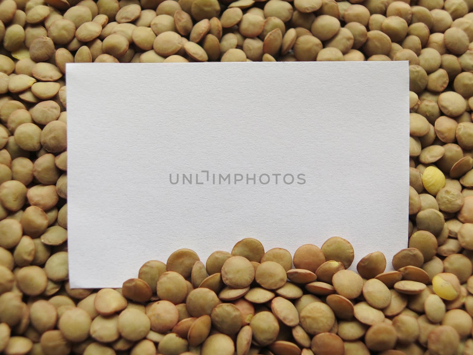 Closeup of White tag on raw lentils background by aroas