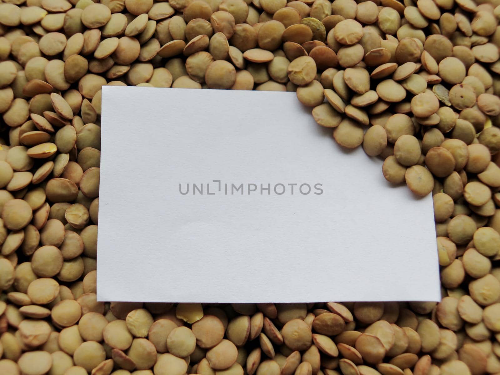 Closeup of White tag on raw lentils background by aroas