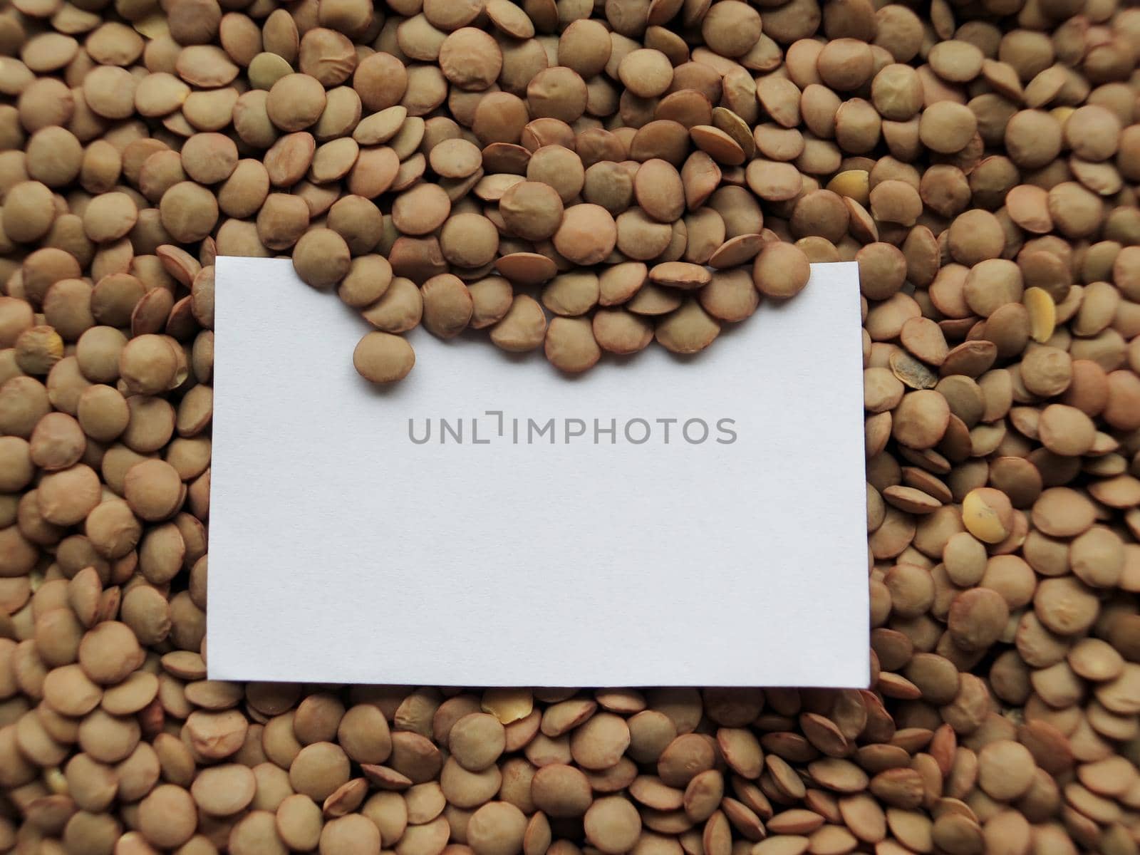 Closeup of White tag on raw lentils background by aroas