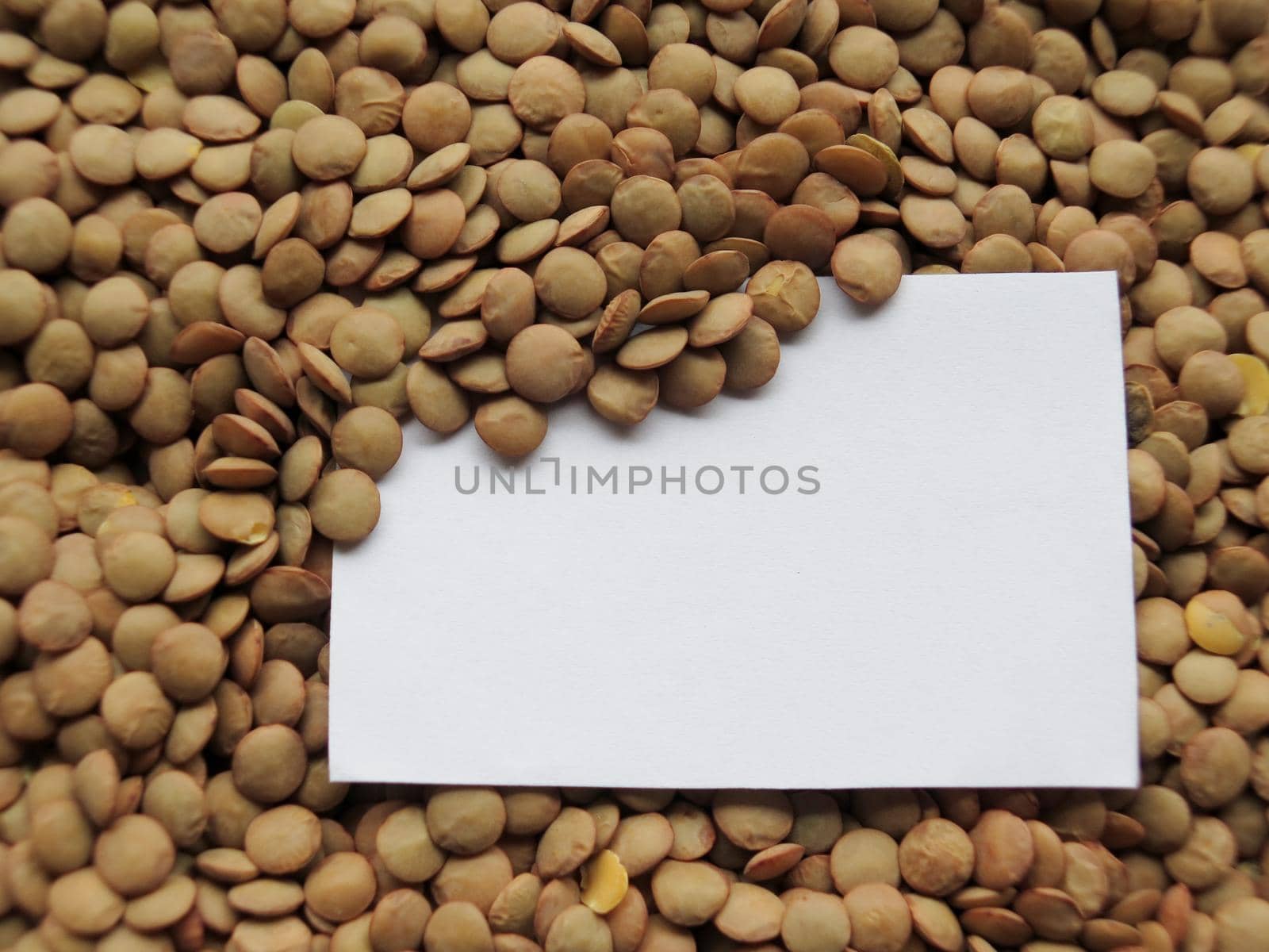 Closeup of White tag on raw lentils background by aroas