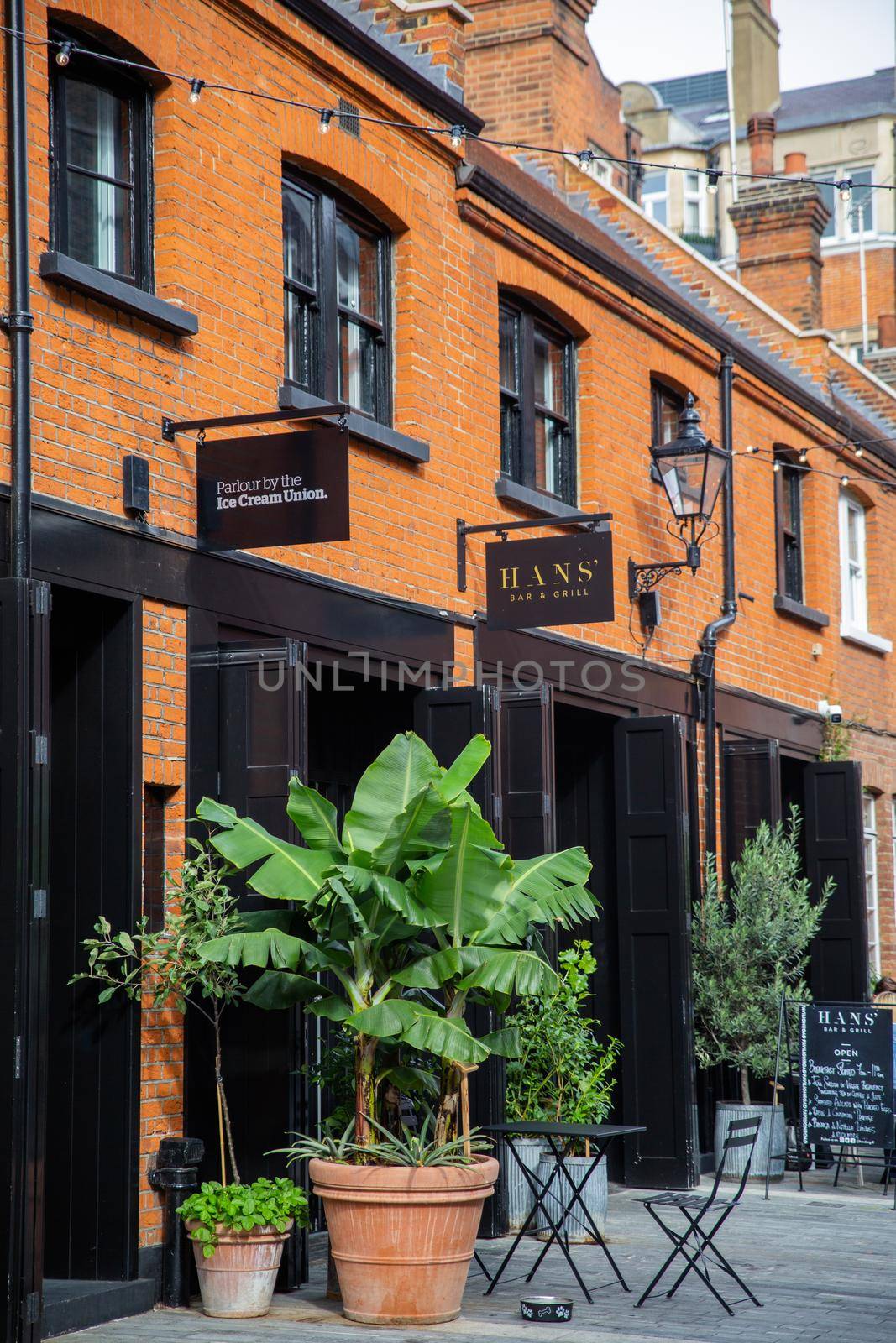 London, UK - February 14, Row of brick buildings with restaurants in Pavilion Road. Beautiful British brick buildings with classic architecture. Colorful London neighborhood