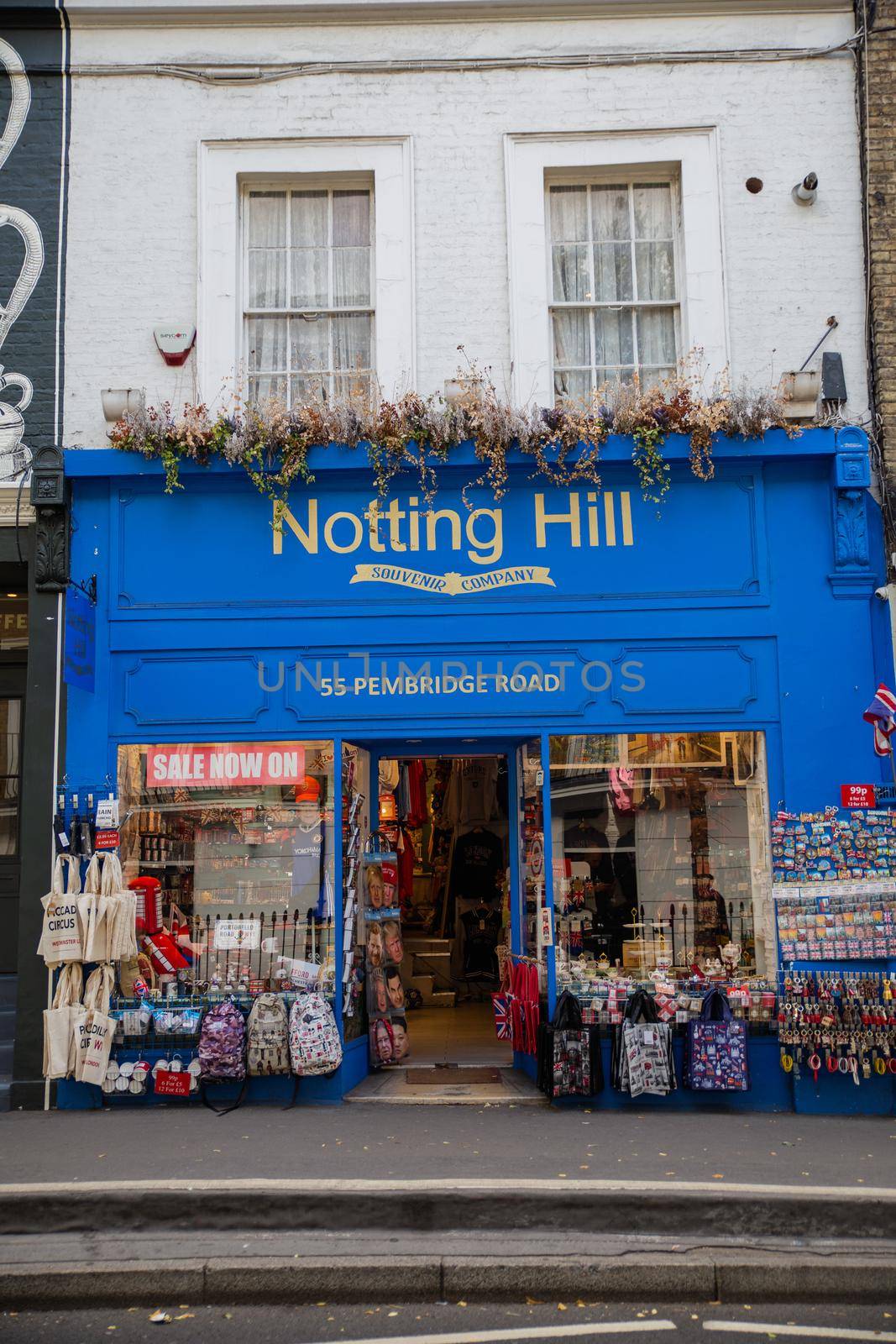 London, UK - February 14, 2020: Front side of blue souvenir store from Notting Hill, London. Blue English building decorated with flowers. Colorful London neighborhood