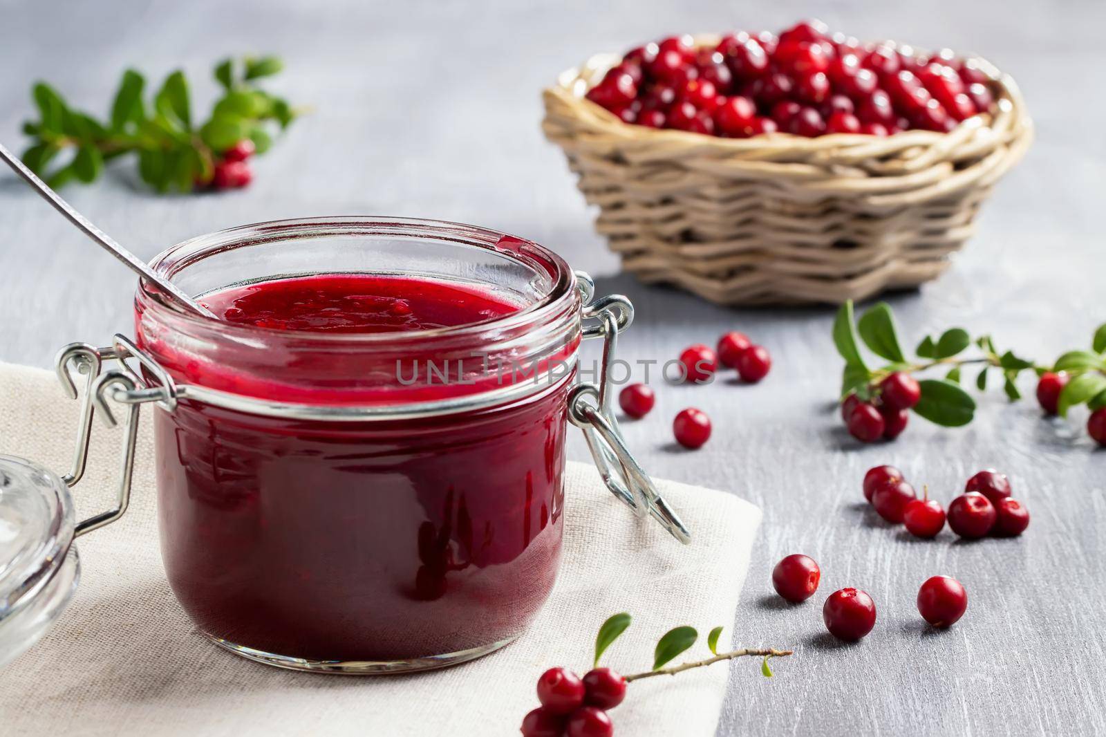 Glass jar with homemade lingonberry sauce. Canning lingonberry sauce by galsand