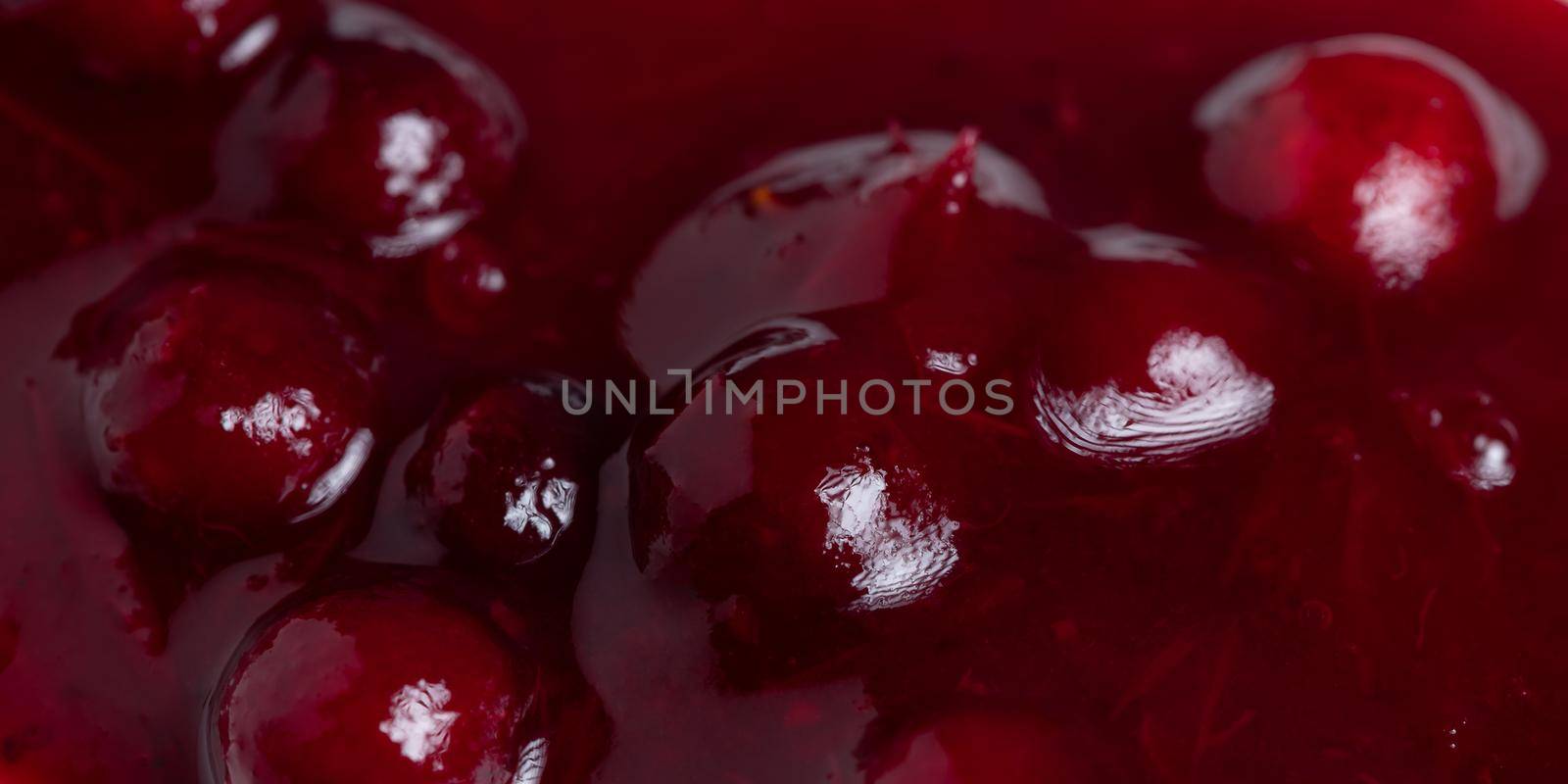Fresh ripe lingonberry sauce close-up. Food background, texture by galsand