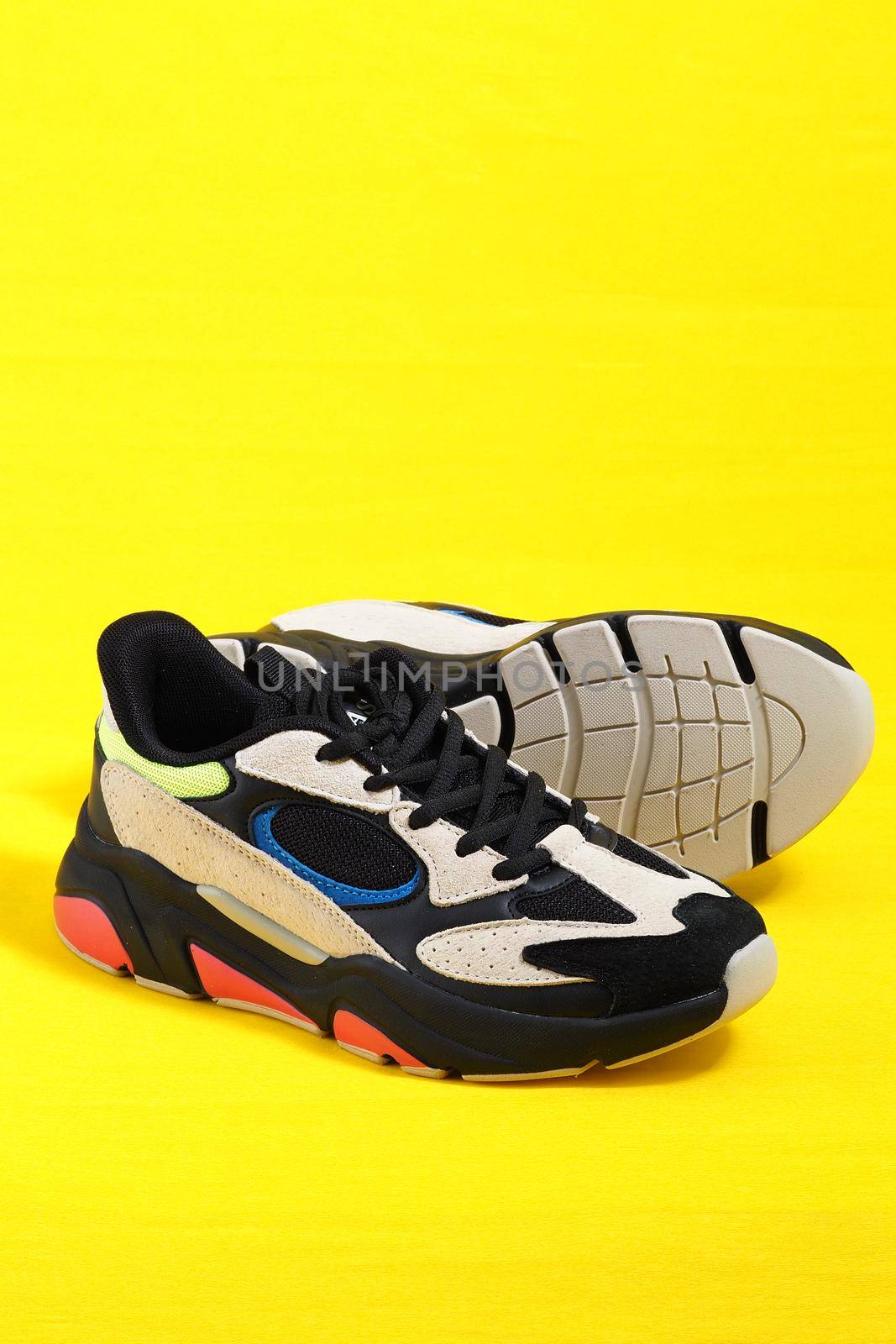 Sports shoes. The sneakers are stylish in isolation on a yellow background. by Olga26