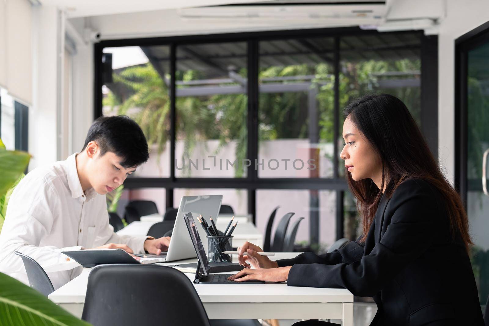 Group of young asian business people working with laptop computer at modern office by nateemee