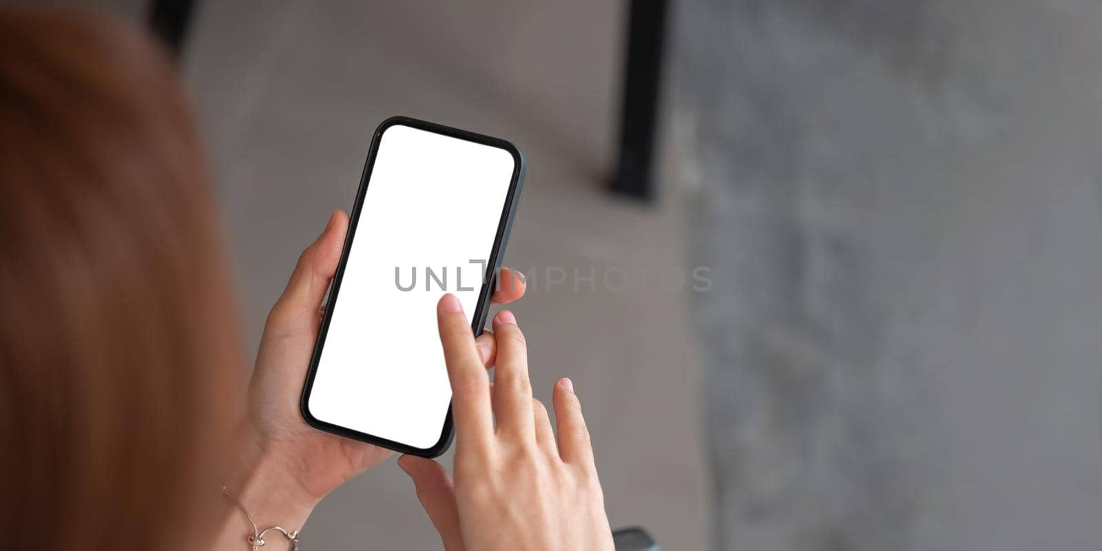 Top view woman hand holding smartphone. Blank screen mobile phone for graphic display montage