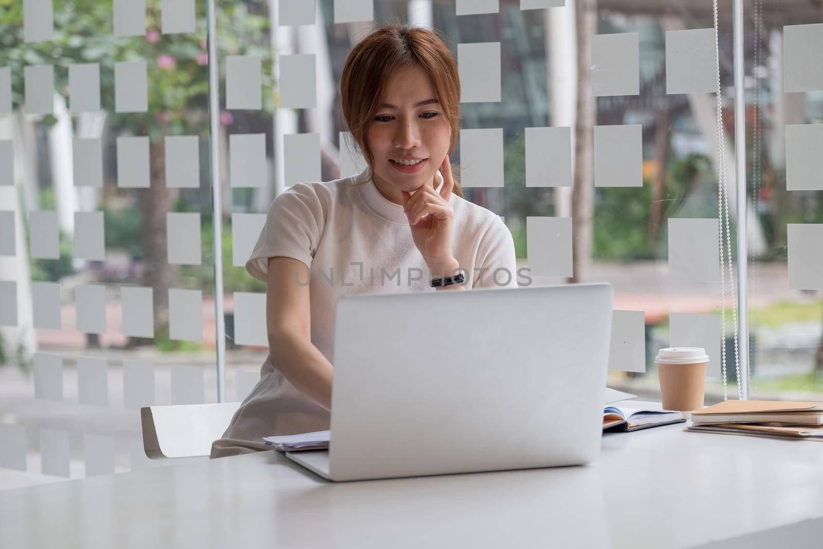 Portrait of asian female working with laptop computer for online business or education concept. by nateemee