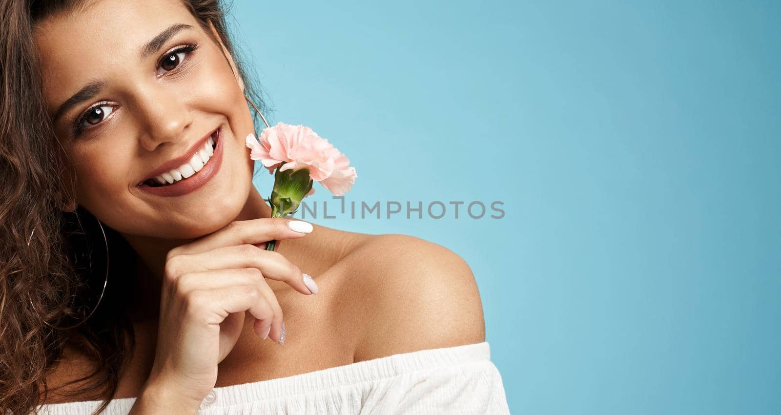 Smiling woman holding clove flower. by SerhiiBobyk