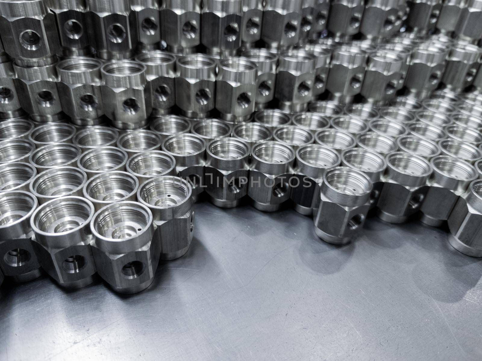 shiny steel industrial production parts after turning - close-up with selective focus