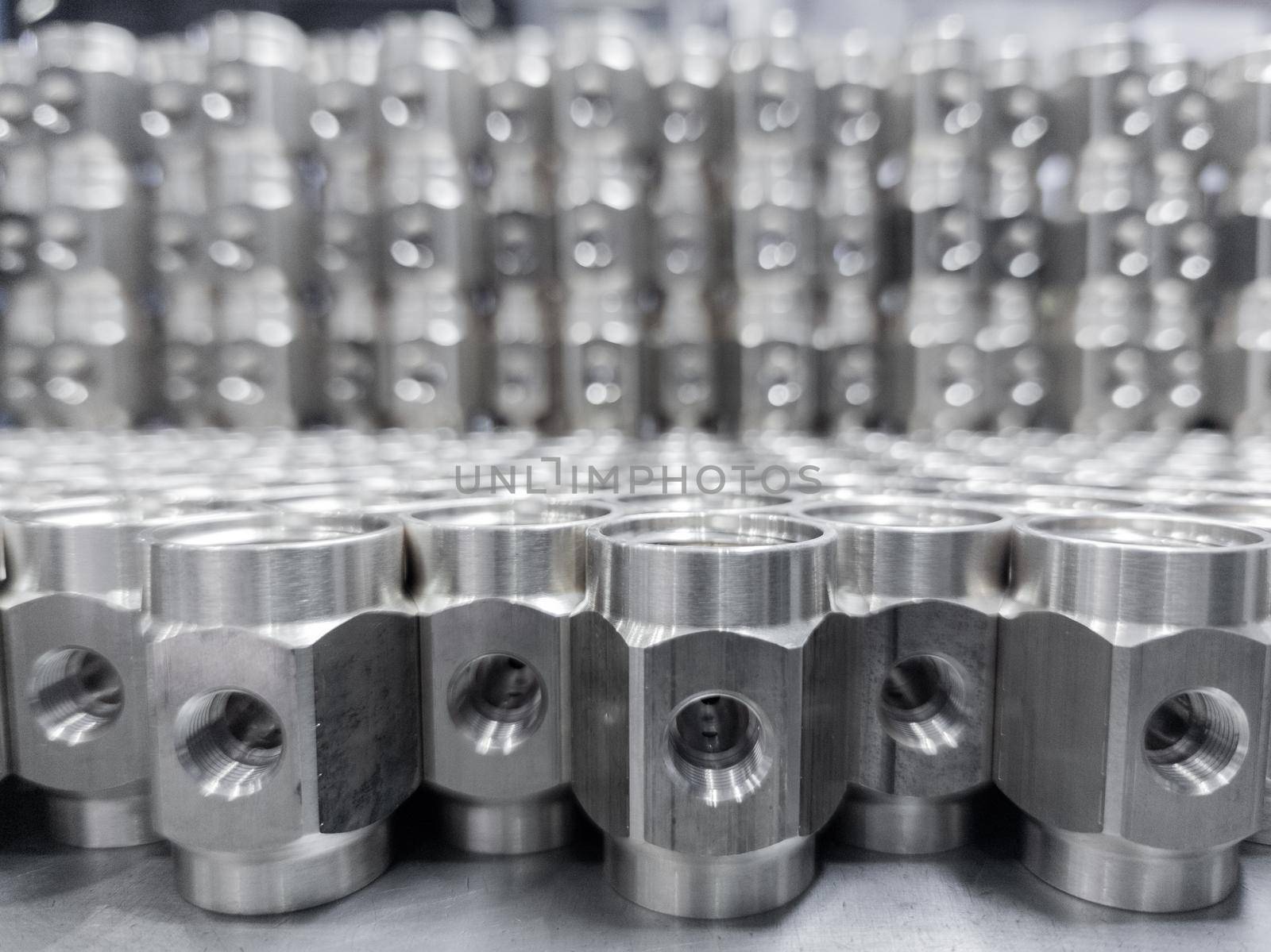 shiny steel industrial production parts after turning - close-up with selective focus