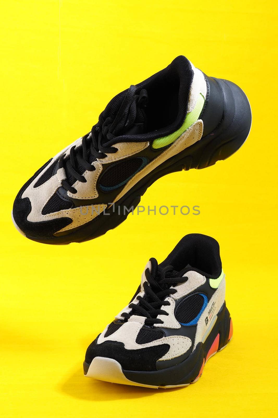 Sneakers stylish women's, yellow background, levitation, isolated close-up. High quality photo